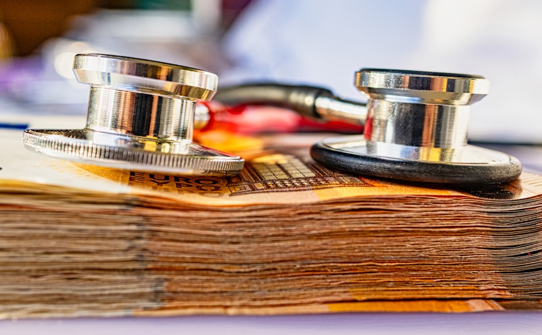 How Much Does COBRA Insurance Cost? 5 a stethoscope on top of a stack of money