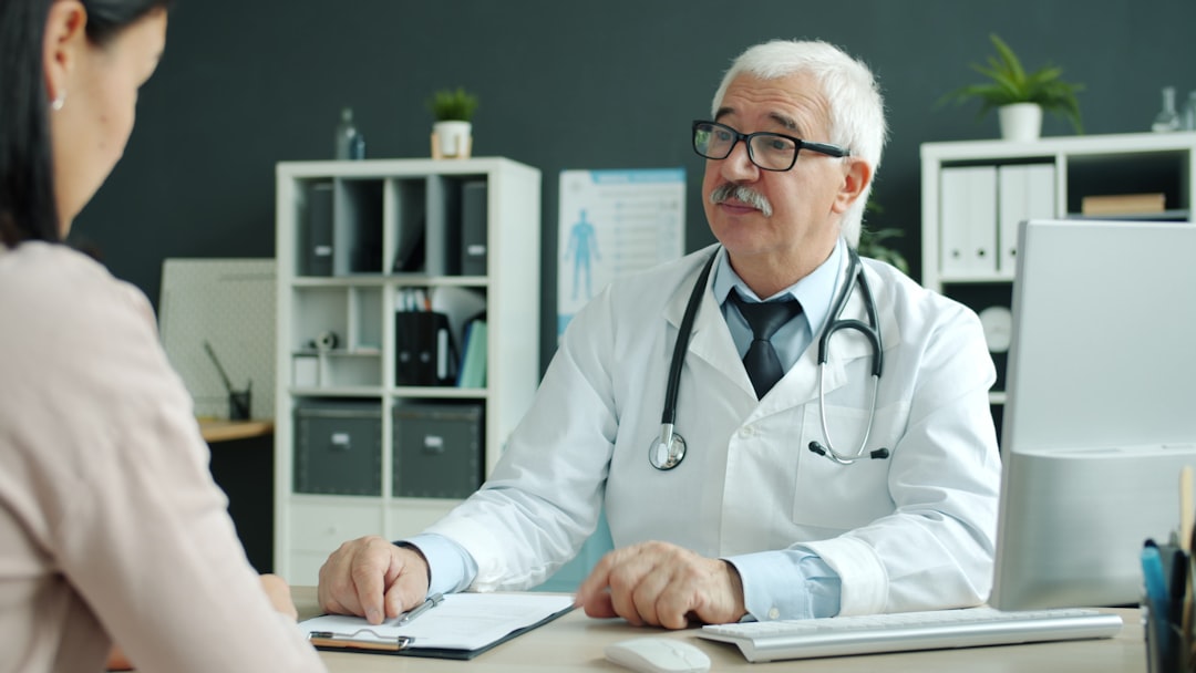 Doctor consults with patient in modern office.