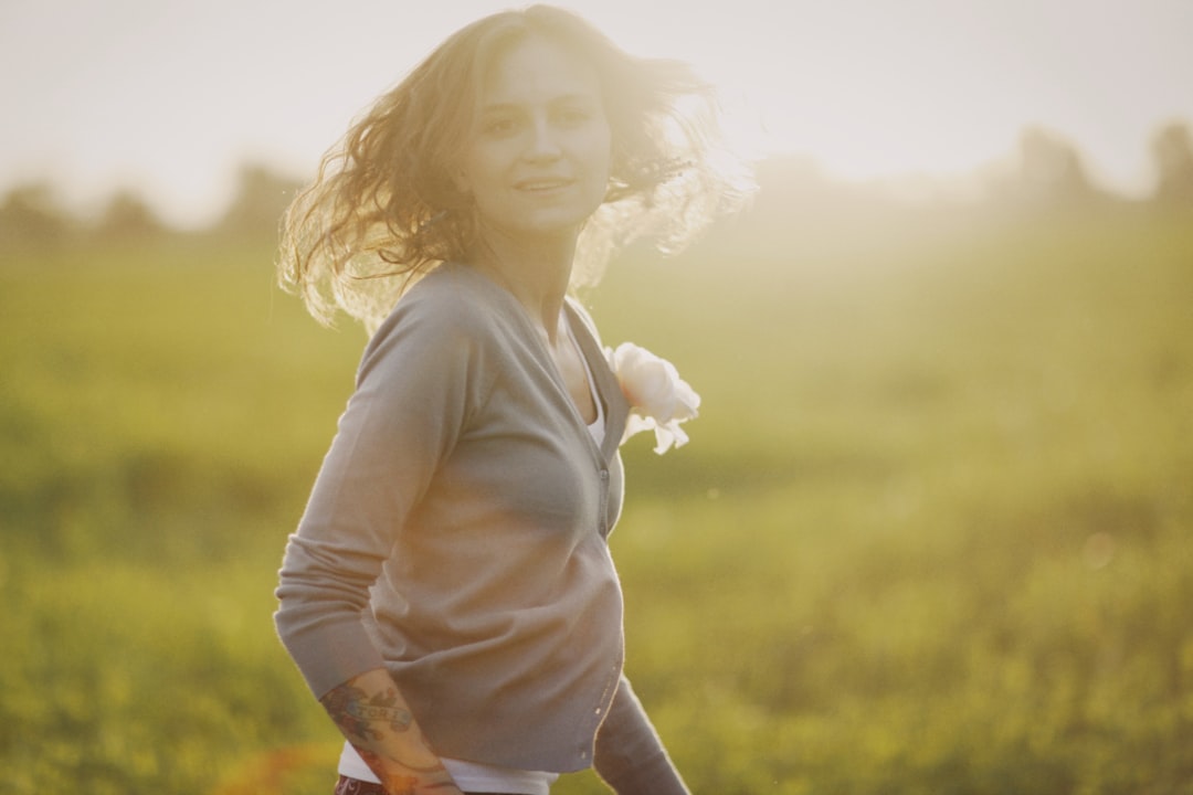 Find a Fertility Doctor (Reproductive Endocrinologist) Near You 6 a woman standing in a field with her hair blowing in the wind
