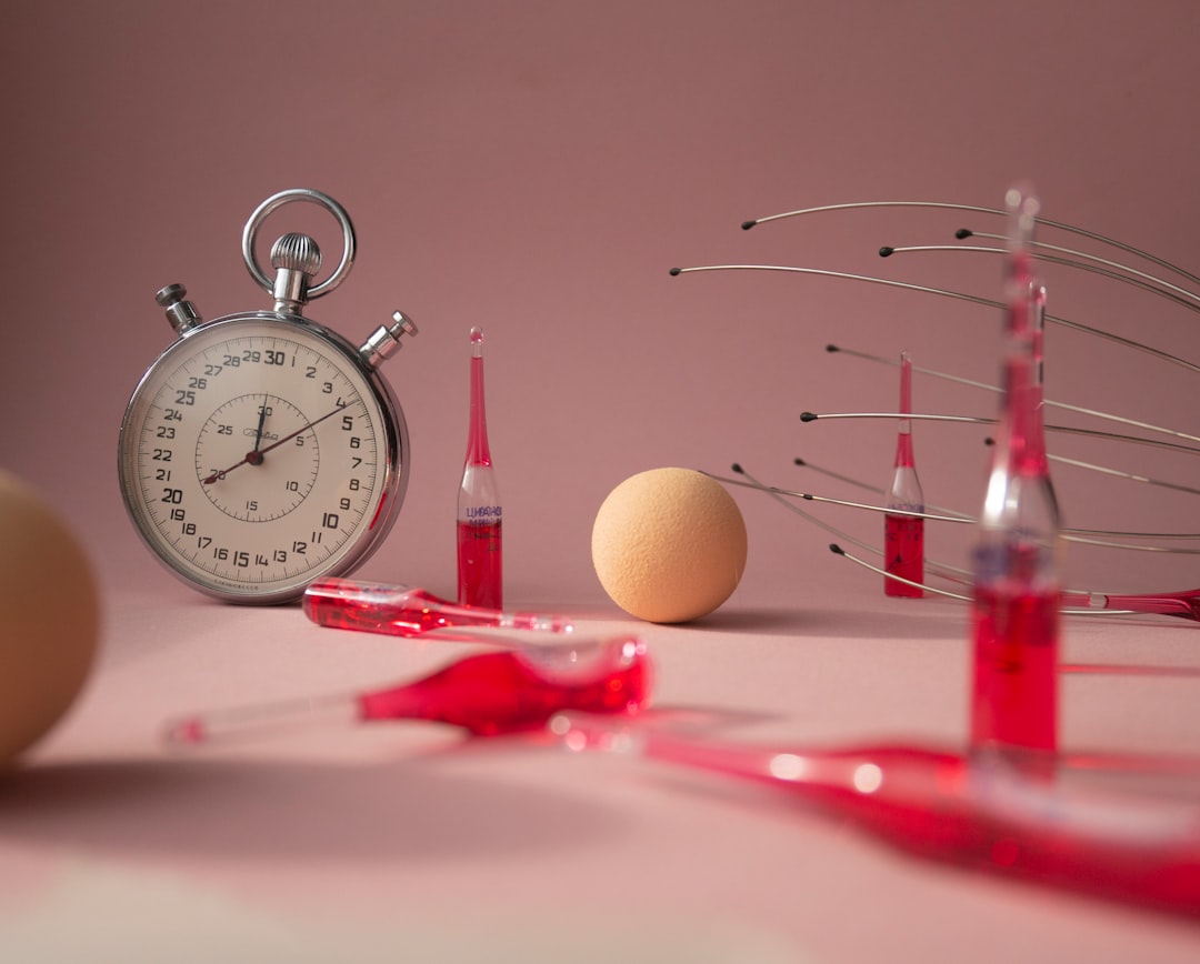 red and silver analog alarm clock