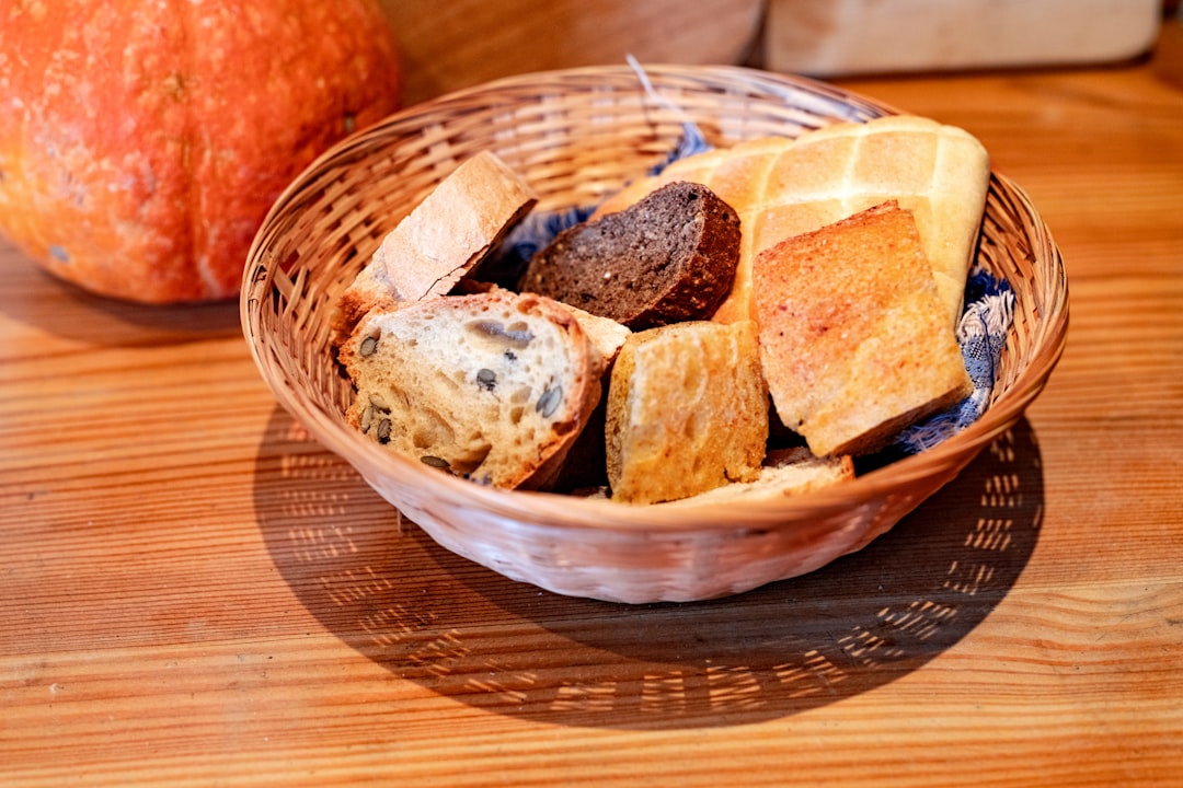 a basket filled with bread next to an orange