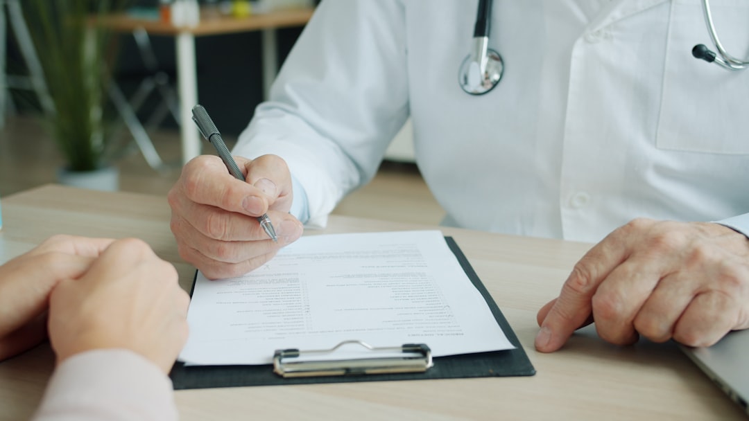 Insurance Reconsideration Appeal Letter Template 1 Doctor writing on a patient's chart