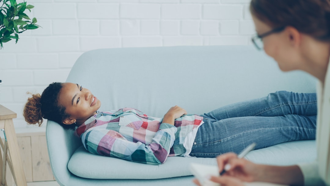 Girl lying on couch during therapy session with counselor