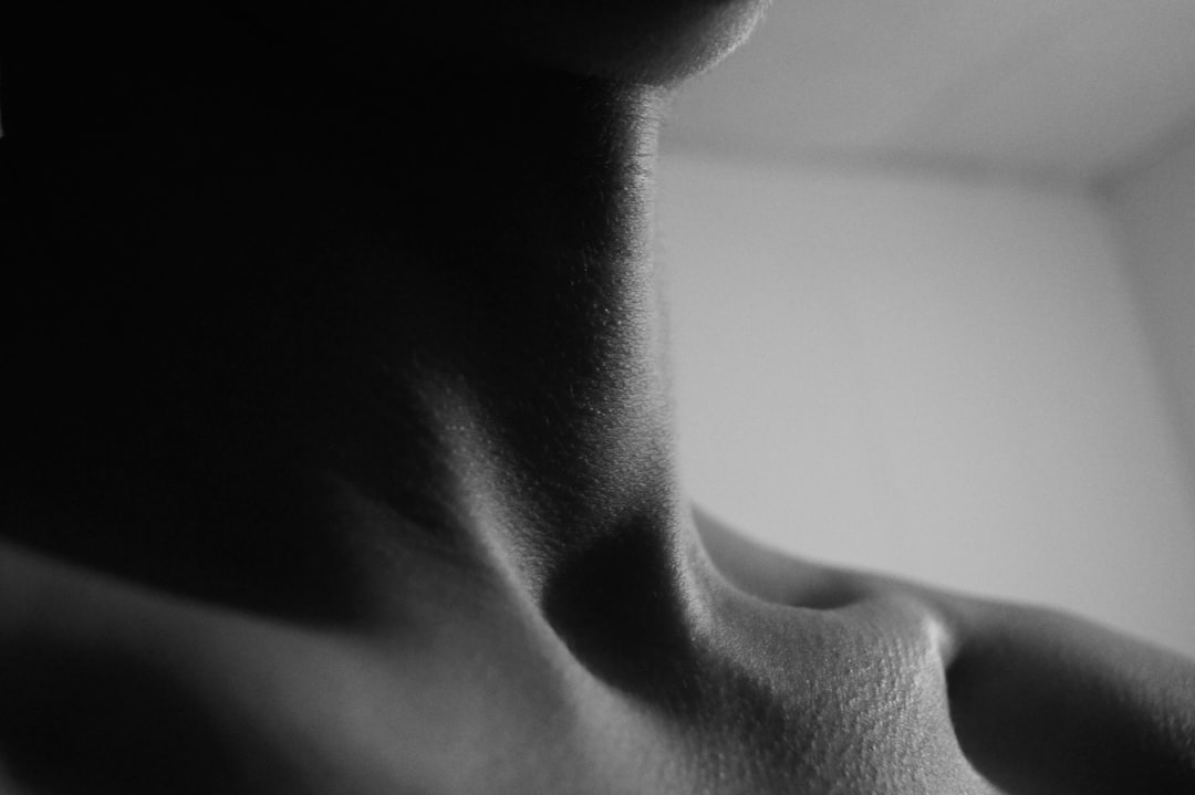 When to Worry About Thyroid Nodules 3 a black and white photo of a woman's neck